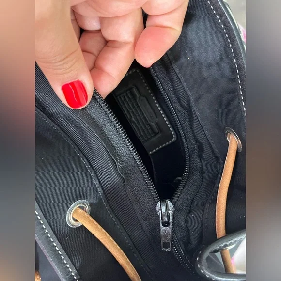 COACH canvas backpack and COACH leather wallet.